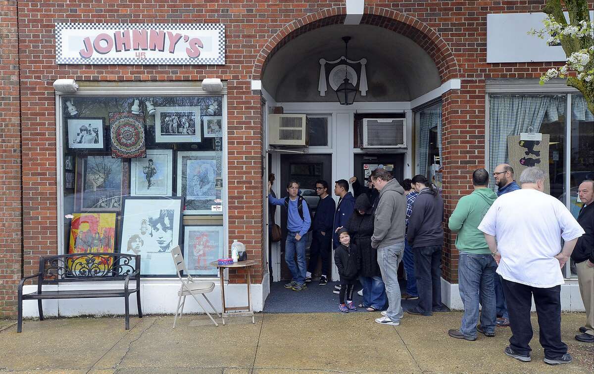 A line of customers stretches out the door during Record Store Day at Johnny's Records in Darien, Conn. on Saturday, April 21, 2017. 