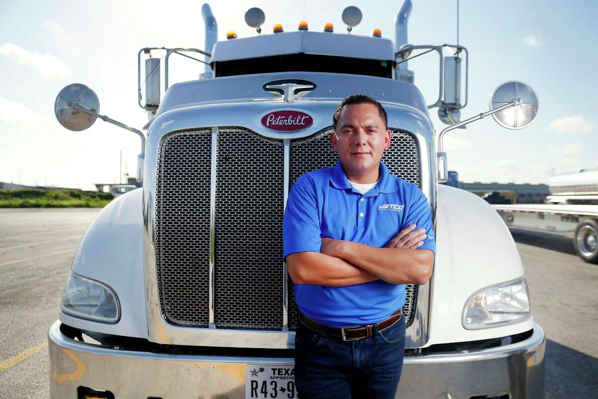 Jorge Chavez, a contract driver for Jetco Delivery, stands in front of his Peterbilt truck at the Exxon Truck Stop at Texas 146 and Barbours Cut Boulevard on Aug. 15, 2020 in La Porte.