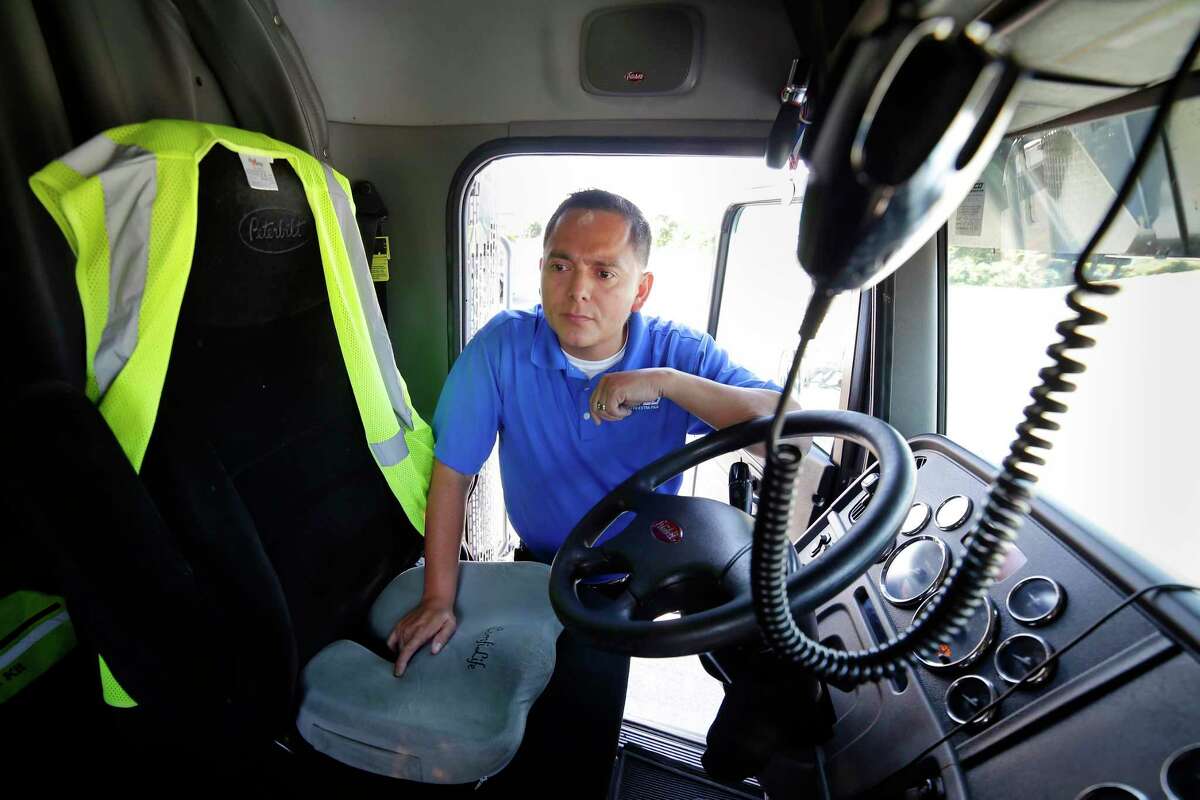 Jorge Chavez, a contract driver for Jetco Delivery, hops into the cab of his Peterbilt semi-tractor at the Exxon Truck Stop at Texas 146 and Barbours Cut Boulevard on Aug. 15, 2020 in La Porte.