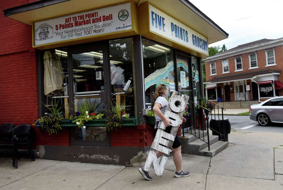 Maura Pulver closes for the day at Five Points Grocery on Wednesday, Aug. 19, 2020, in Saratoga Springs, N.Y. Pulver, who owns the business, will close the store and move into a different building nearby to continue selling food. (Will Waldron/Times Union)