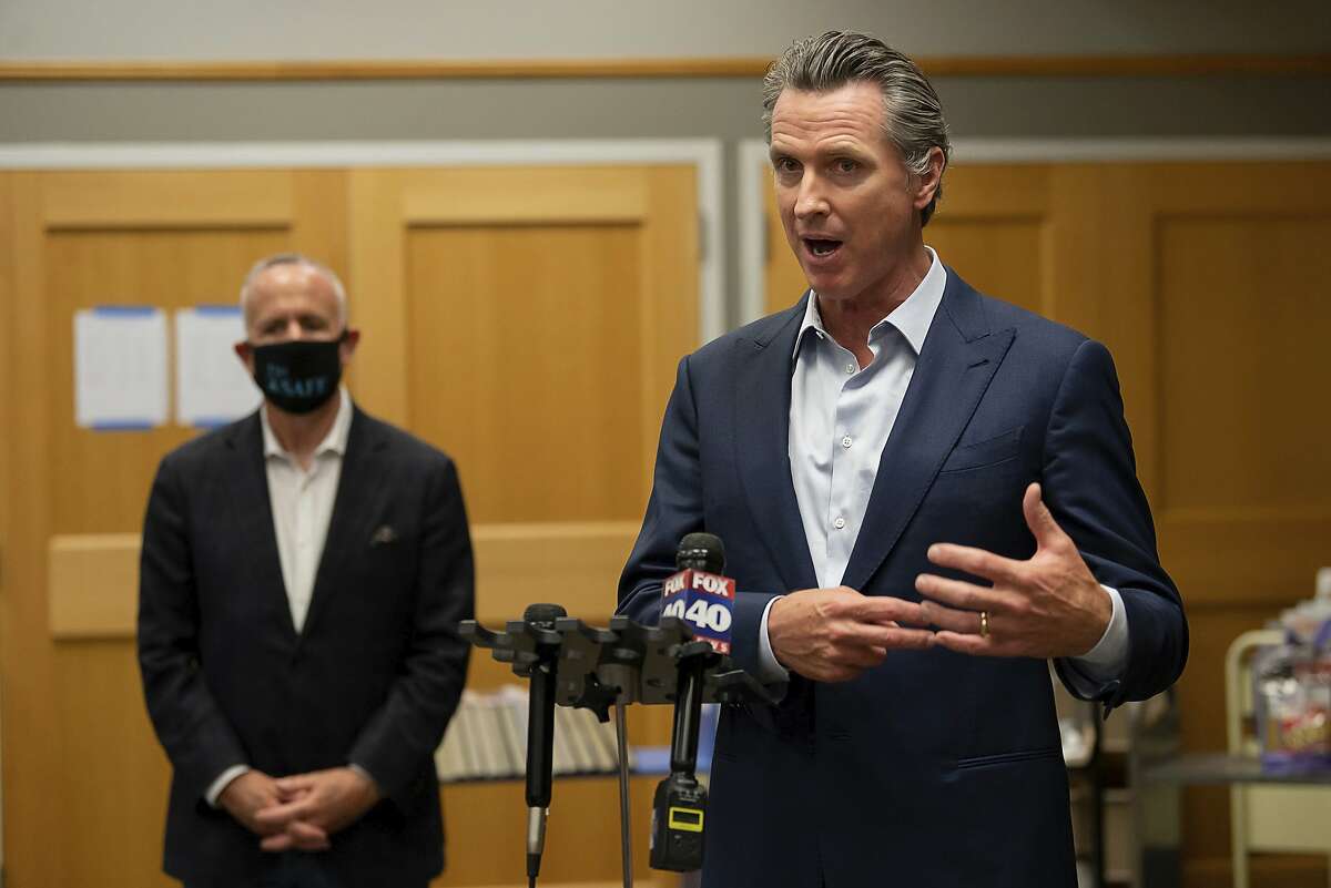Gov. Gavin Newsom speaks during a tour of a cooling center with Sacramento Mayor Darrell Steinberg at the Tsakopoulos Library Galleria on Tuesday, Aug. 18, 2020, in Sacramento, Calif. Gov. Newsom declared an emergency Tuesday over wildfires burning throughout California as the state's power grid operator pleaded with residents and businesses to continue conserving energy to avoid rolling blackouts. (Paul Kitagaki Jr./The Sacramento Bee via AP, Pool)