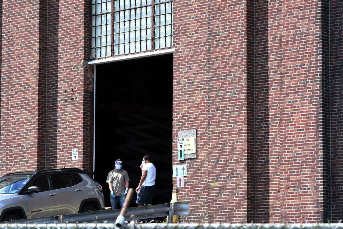 Production crew members prepare the Schenectady Armory for filming of an Amazon Prime series called 