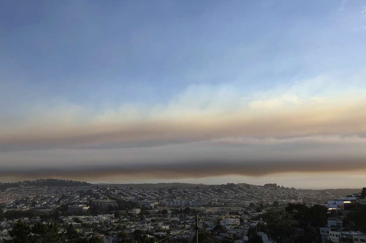 Smoke from wildfires hangs over San Francisco, Tuesday, Aug. 18, 2020. Thousands of people are under orders to evacuate regions around the San Francisco Bay Area as nearly 40 wildfires blaze throughout the state. Smoke has blanketed the city of San Francisco and California is coping with a blistering heat wave.