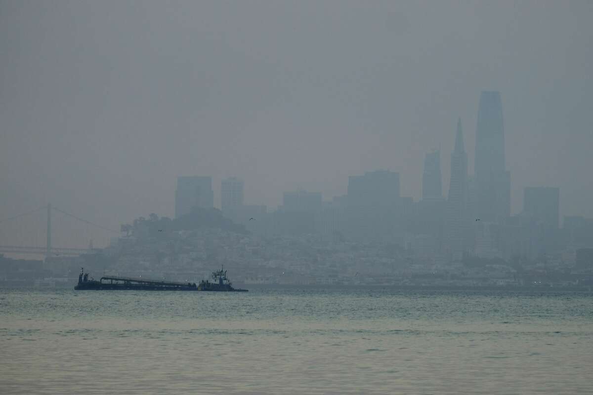 FILE - The San Francisco skyline is barely visible through smoke from wildfires on Wednesday, August 19, 2020, in this view of Sausalito, California. 