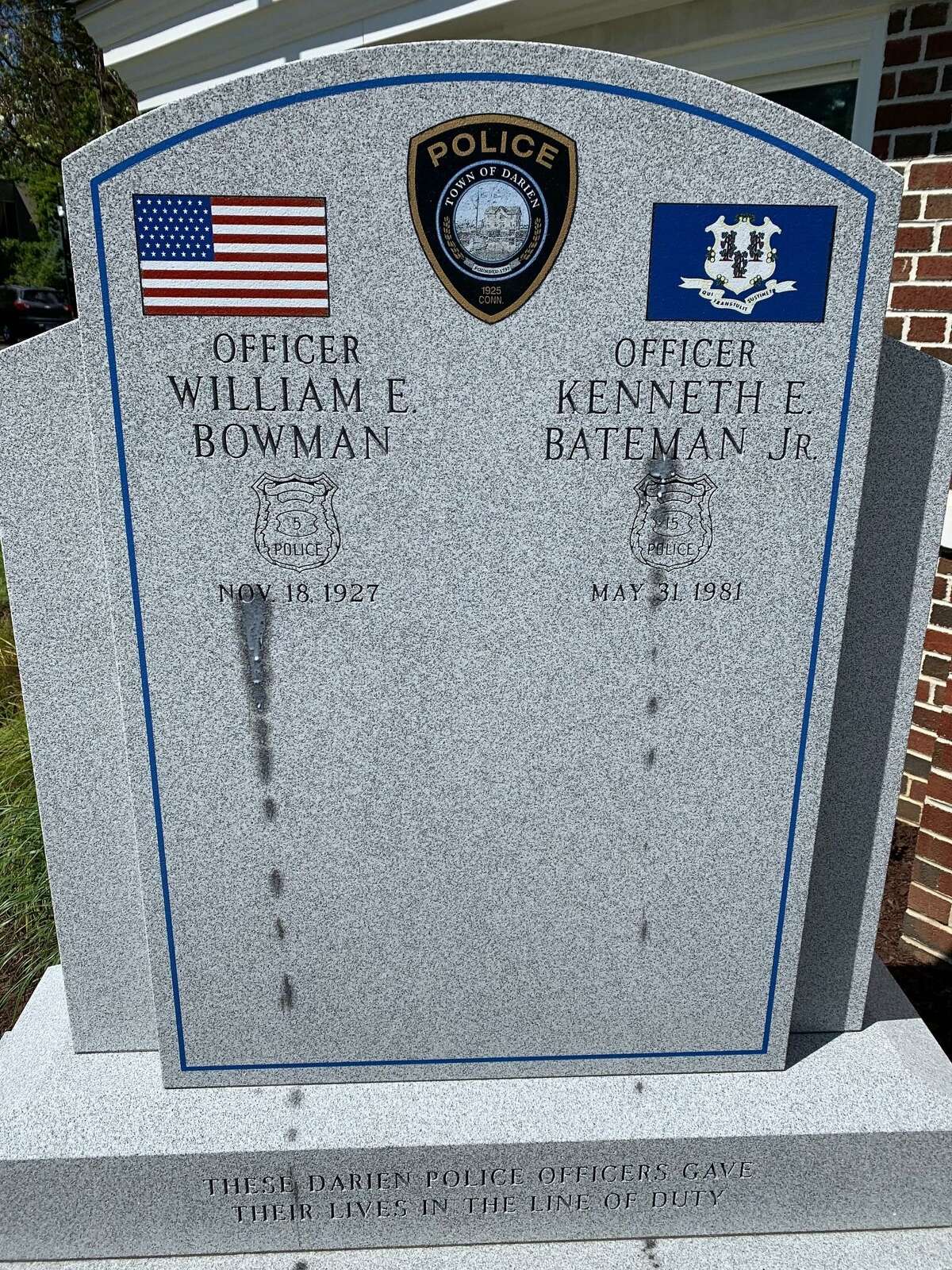 A monument dedicated to the memory of two fallen Darien police officers was defaced using what police believe to be a wax paintball gun.