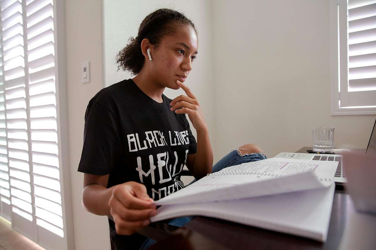 Aniyah Story looks through her notes during her Advanced Placement American History class at her home in San Leandro, Calif. on August 17, 2020. Story is an advocate for bill AB2016, which will make ethnic studies a graduation requirement for high school students. Currently lawmakers are divided over the bill, saying that while they agree ethnic studies should be expanded there is disagreement over what lessons the curriculum should include.