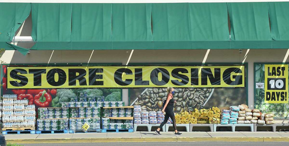 Customers of Fairway Market are greeted with store closing signs as they shop on Aug. 12, 2020, at the store at 699 Canal St., in Stamford, Conn.