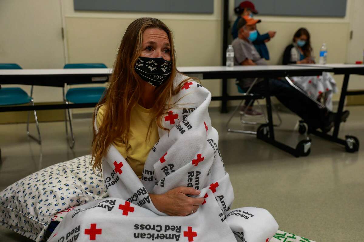 Evacuee Shawnee Whaley, 57, who believes her house burned down sits in the Red Cross Shelter at the Ulatis Cultural Center after escaping the LNU Lightning Complex Fire in Vacaville , Calif., on Wednesday, August 19, 2020.