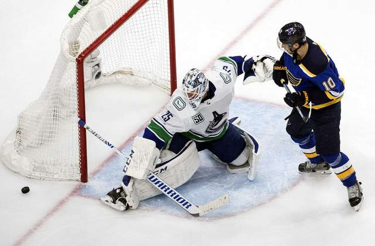The Blues’ Brayden Schenn (10) is stopped by Vancouver Canucks goalie Jacob Markstrom (25) during the third period Wednesday night in Edmonton.