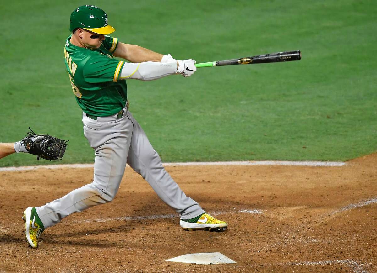 ANAHEIM, CA - AUGUST 10: Matt Chapman #26 of the Oakland Athletics hits a three-run triple in the fourth inning against the Los Angeles Angels at Angel Stadium of Anaheim on August 10, 2020 in Anaheim, California. (Photo by John McCoy/Getty Images)