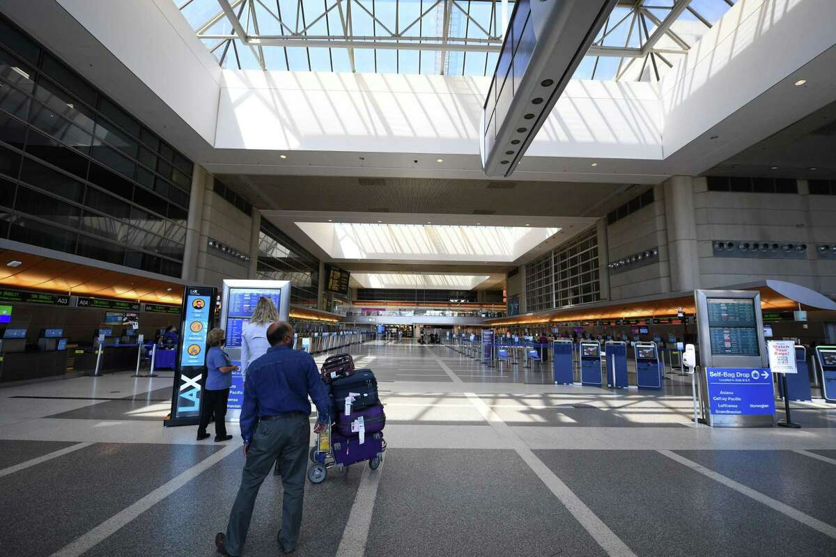 A man arrives at a largely empty Tom Bradley International Terminal at Los Angeles International airport on August 12, 2020 in Los Angeles during the coronavirus pandemic. - On August 11, 559,420 passengers passed through T.S.A. security checks, compared with just over 2.3 million passengers on the same day one year ago. At the same time the August 11, 2020 number is a large jump up from April 12, 2020 when only 90,510 passengers traveled out of US airports, according to U.S. Transportation Security Administration (TSA) records. (Photo by Robyn Beck / AFP) (Photo by ROBYN BECK/AFP via Getty Images)