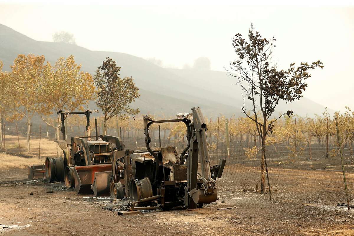 Burnt farm machinery at La Borgata Winery and Distillery after LNU Lightning Complex fire burned in Vacaville, Calif., on Thursday, August 20, 2020.