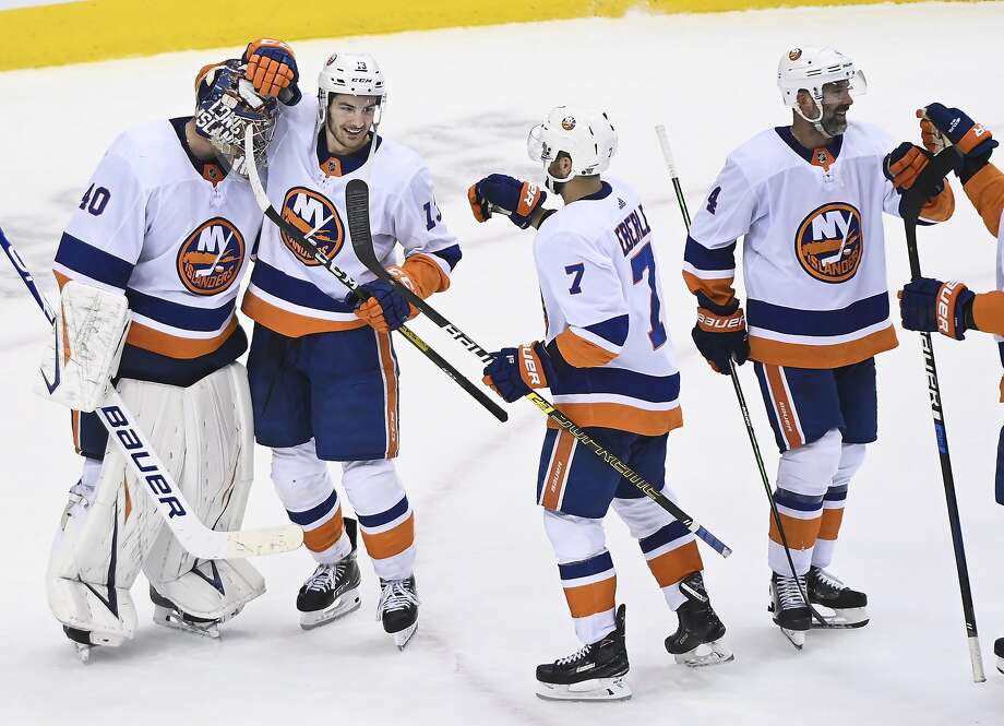 New York Islanders goaltender Semyon Varlamov (40) celebrates with teammates Mathew Barzal (13) and Jordan Eberle (7) after they eliminated the Washington Capitals following an NHL Stanley Cup playoff hockey game in Toronto, Thursday, Aug. 20, 2020. (Nathan Denette/The Canadian Press via AP) Photo: Nathan Denette / Associated Press
