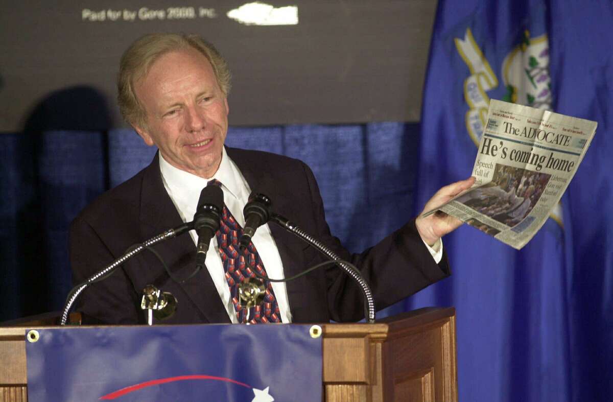 Vice presidential candidate Sen. Joseph Lieberman, D-Conn., holds up a copy of his hometown newspaper, The (Stamford) Advocate, during a campaign speech in Stamford, Wednesday, Aug. 9, 2000.
