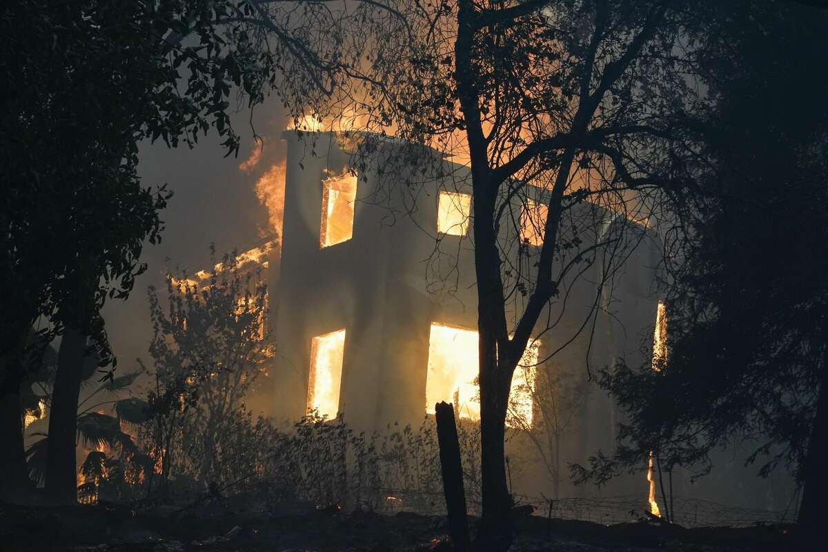 A home burns as the CZU August Lightning Complex Fire passes through on Thursday, Aug. 20, 2020, in Bonny Doon, Calif.