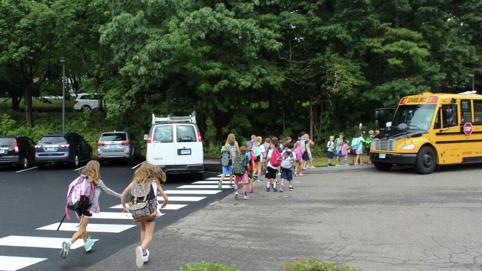 Students board buses after the first day of school on Sept. 1, 2016 at Mill Hill Elementary School in Fairfield, Conn.