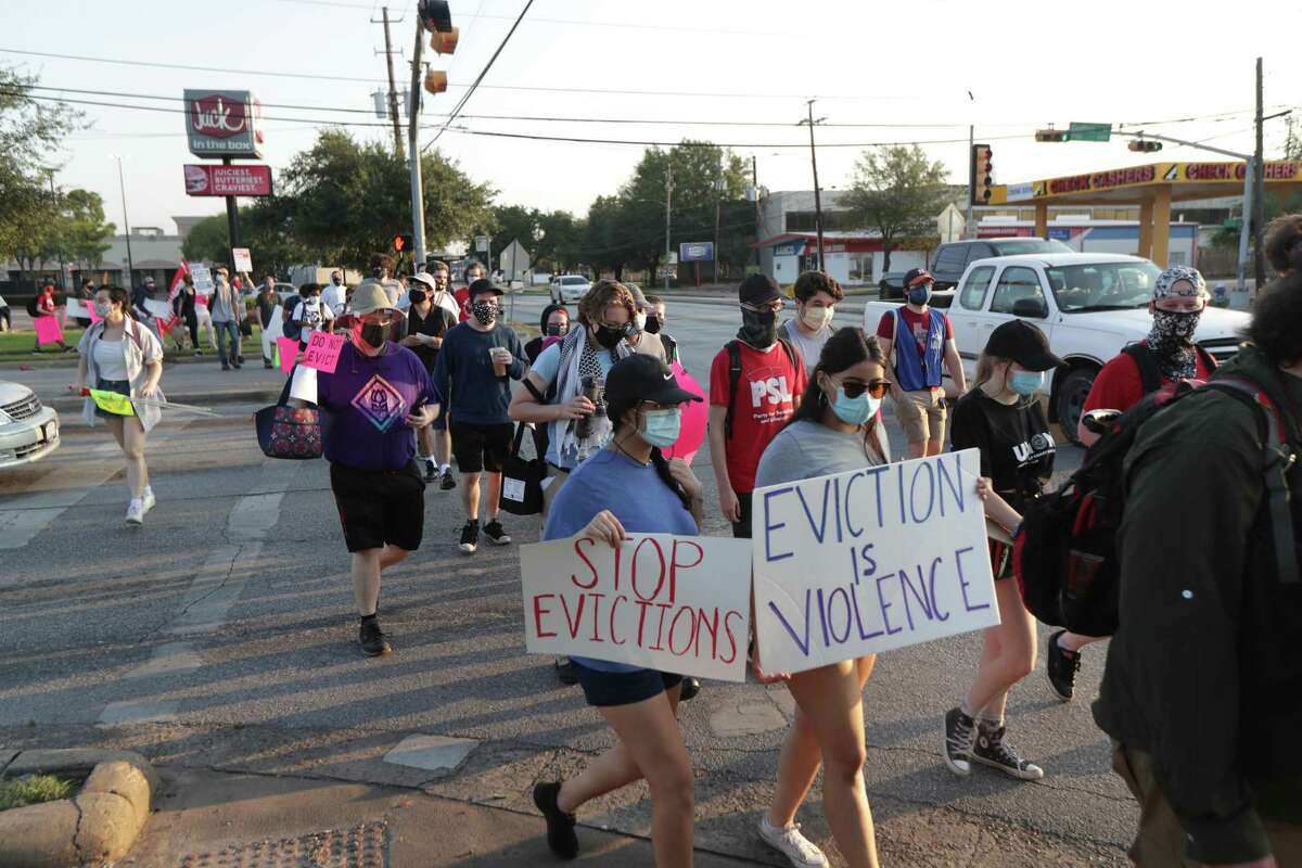 Protesters cross the street during a protest regarding evictions going on at the court, 6000 Chimney Rock Road, Friday, Aug. 21, 2020, in Houston.