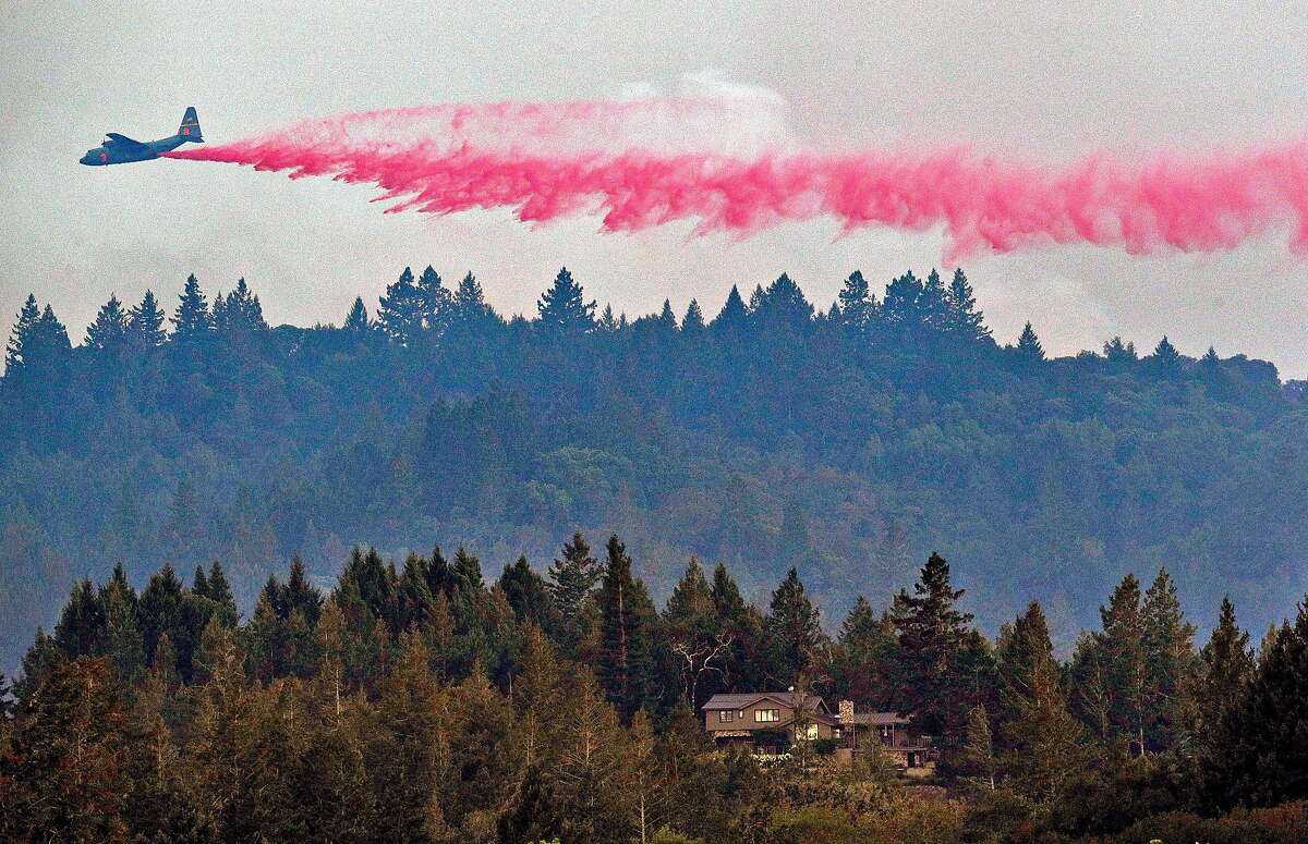 Fire air support planes drop fire retardant on the Walbridge Fire in the mountain range west of Healdsburg, Calif., on Thursday, August 20, 2020.