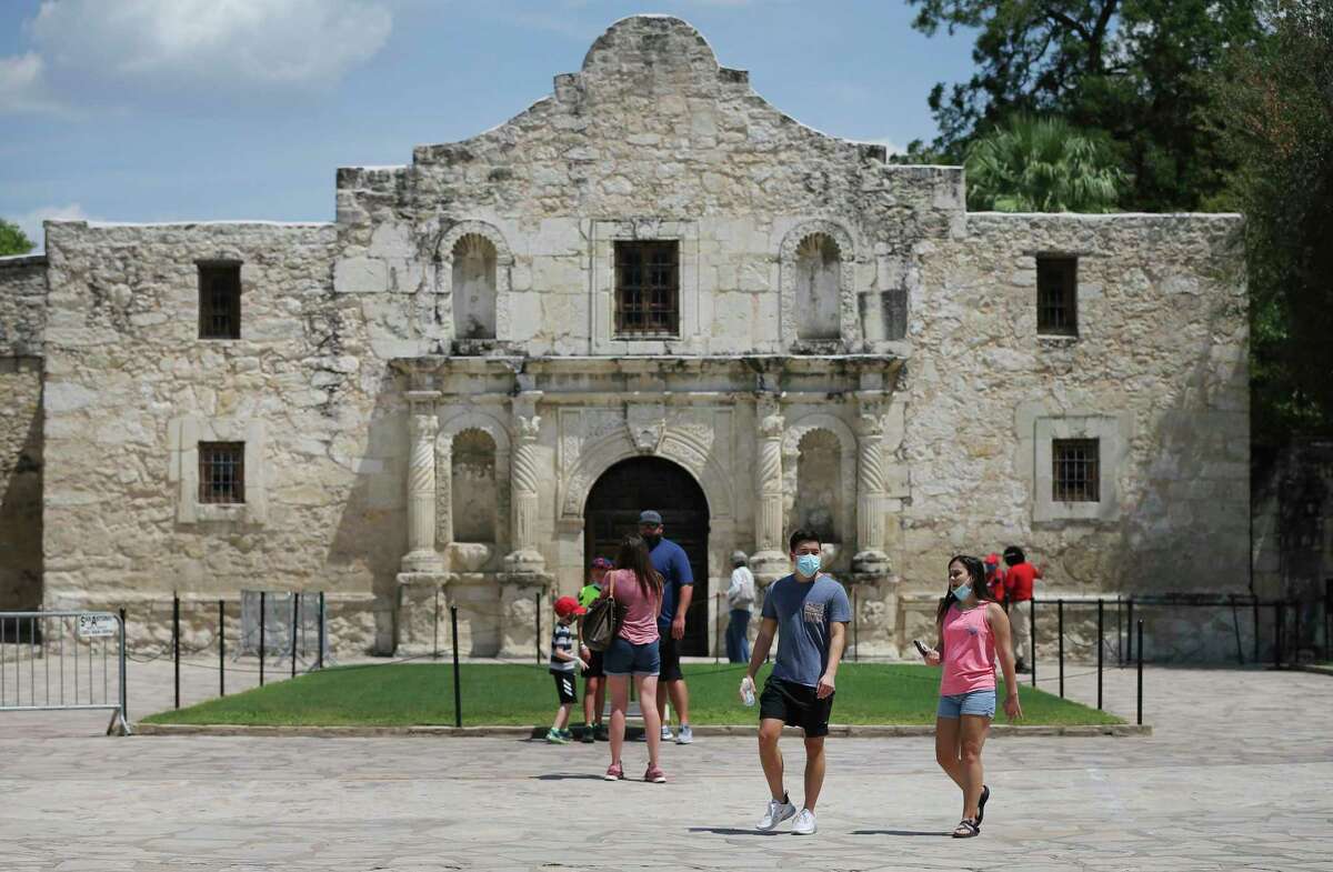 Visitors stroll the grounds at the Alamo on Friday, Aug. 21, 2020. The grounds reopened Thursday to allow visitors in limited capacity to tour around the monument. They are open 9 a.m.-5:30 p.m. The only building open is the gift shop, 10 a.m.-5:30 p.m.