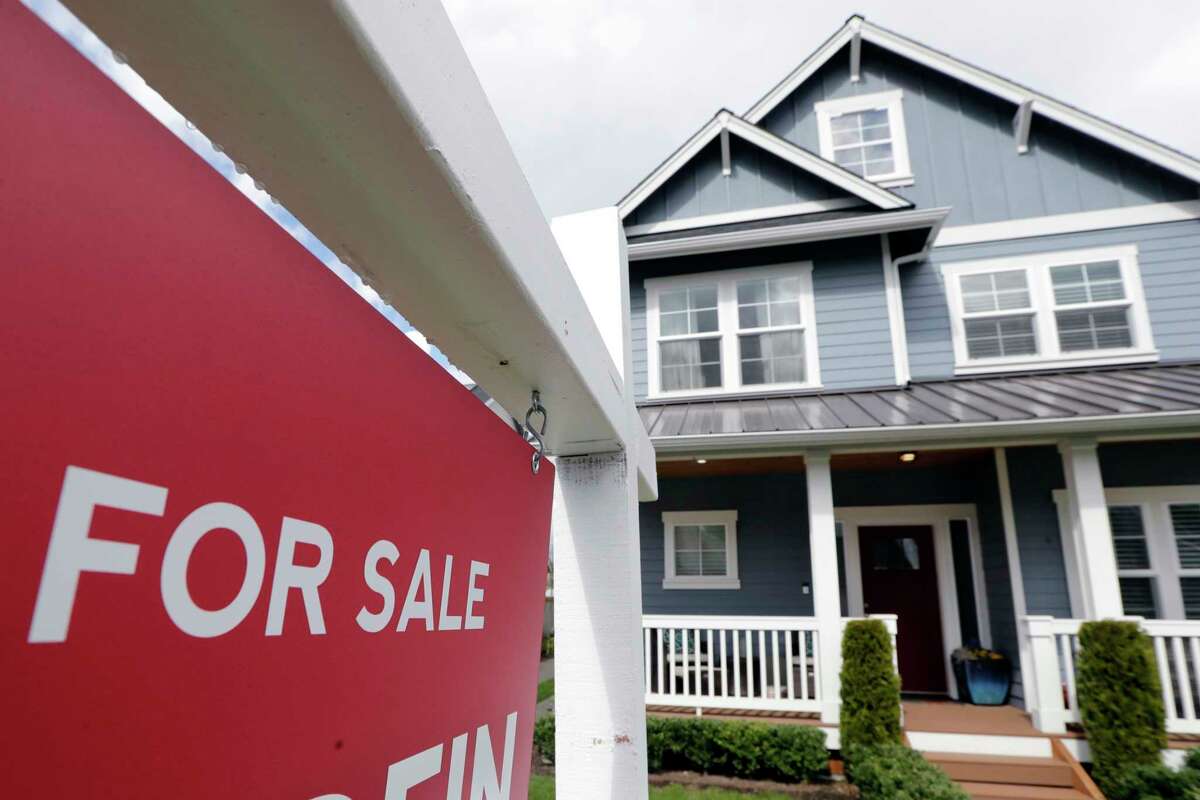 FILE - In this April 1, 2020 photo, a "For Sale" sign stands in front of a home that is in the process of being sold in Monroe, Wash., outside of Seattle.  (AP Photo/Elaine Thompson, File)