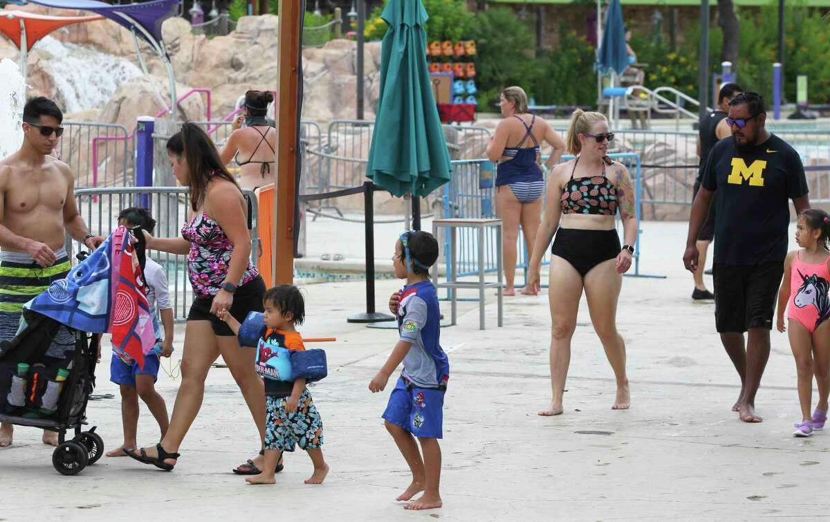 Visitors walk in the Aquatica water park area as Seaworld San Antonio entertains a limited amount of guests on July 31, 2020.