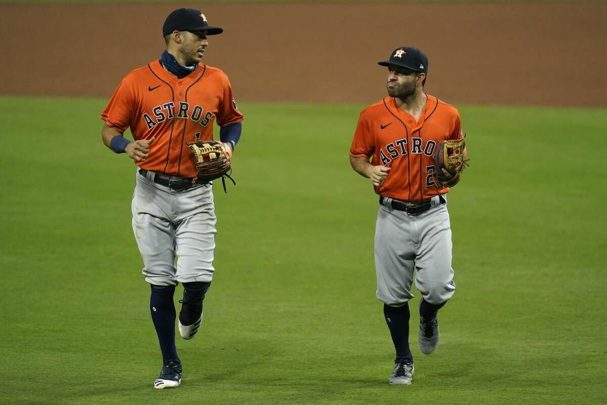 Houston Astros shortstop Carlos Correa, left, speaks with second baseman Jose Altuve at the end of the eighth inning in a baseball game against the San Diego Padres, Friday, Aug. 21, 2020, in San Diego. (AP Photo/Gregory Bull)