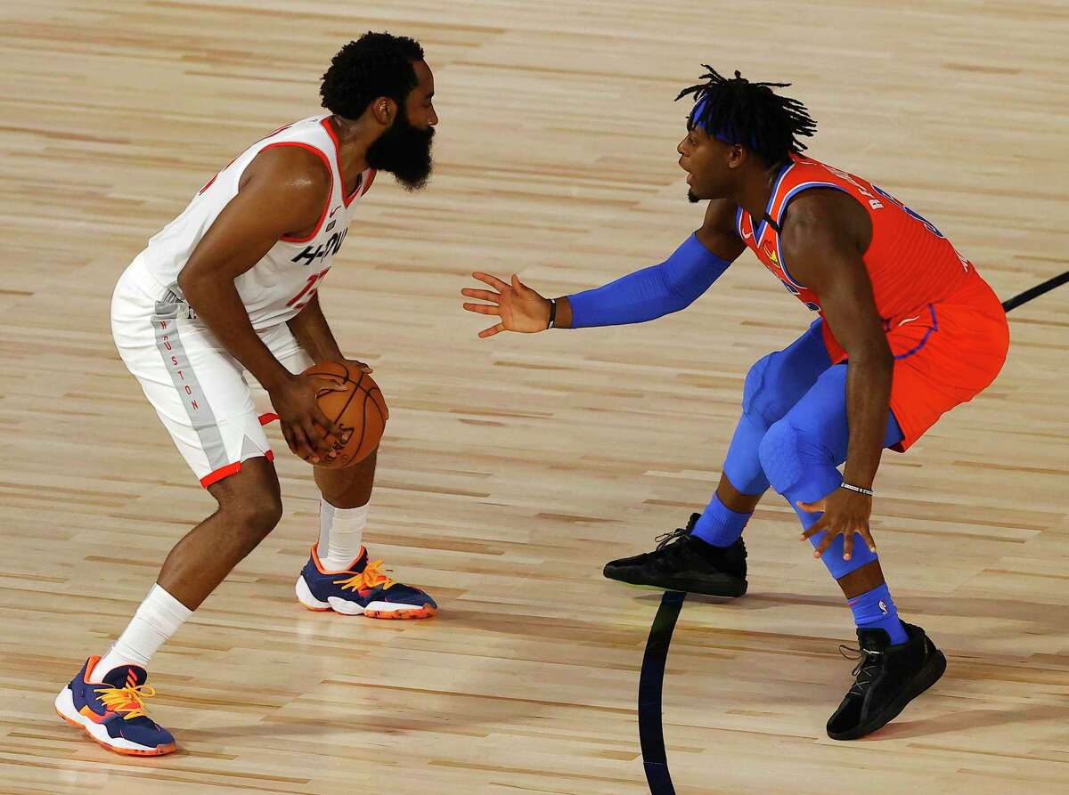 Thunder rookie Lu Dort, right, says that in guarding James Harden, “the hardest thing is just when he stays in place and starts dribbling the ball. You never know what move he’s going to do or where he’s going to go.”