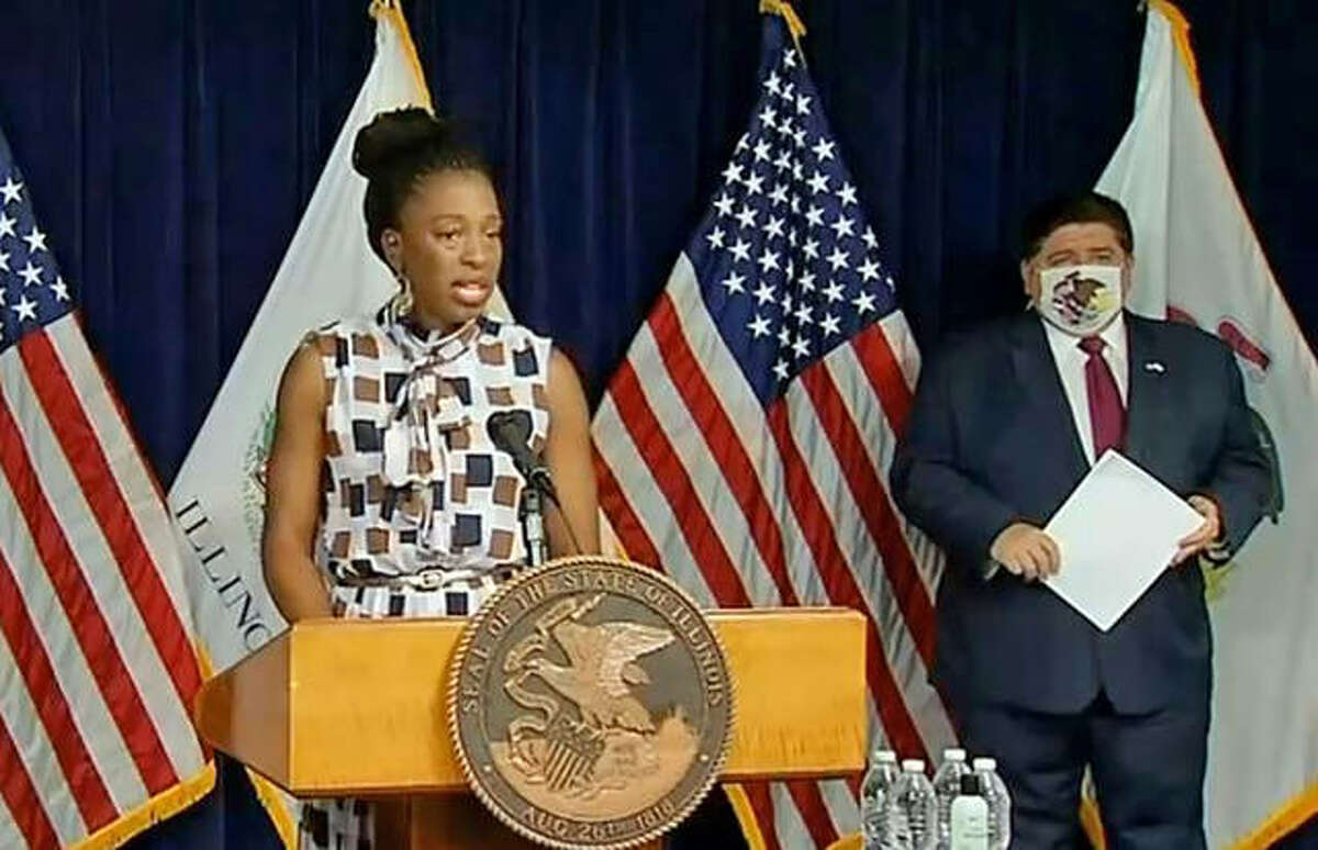 File photo: Illinois Department of Public Health (IDPH) Director Dr. Ngozi Ezike addresses the press during a daily COVID-19 press briefing, Gov. J.B. Pritzker stands to the right waiting to speak.