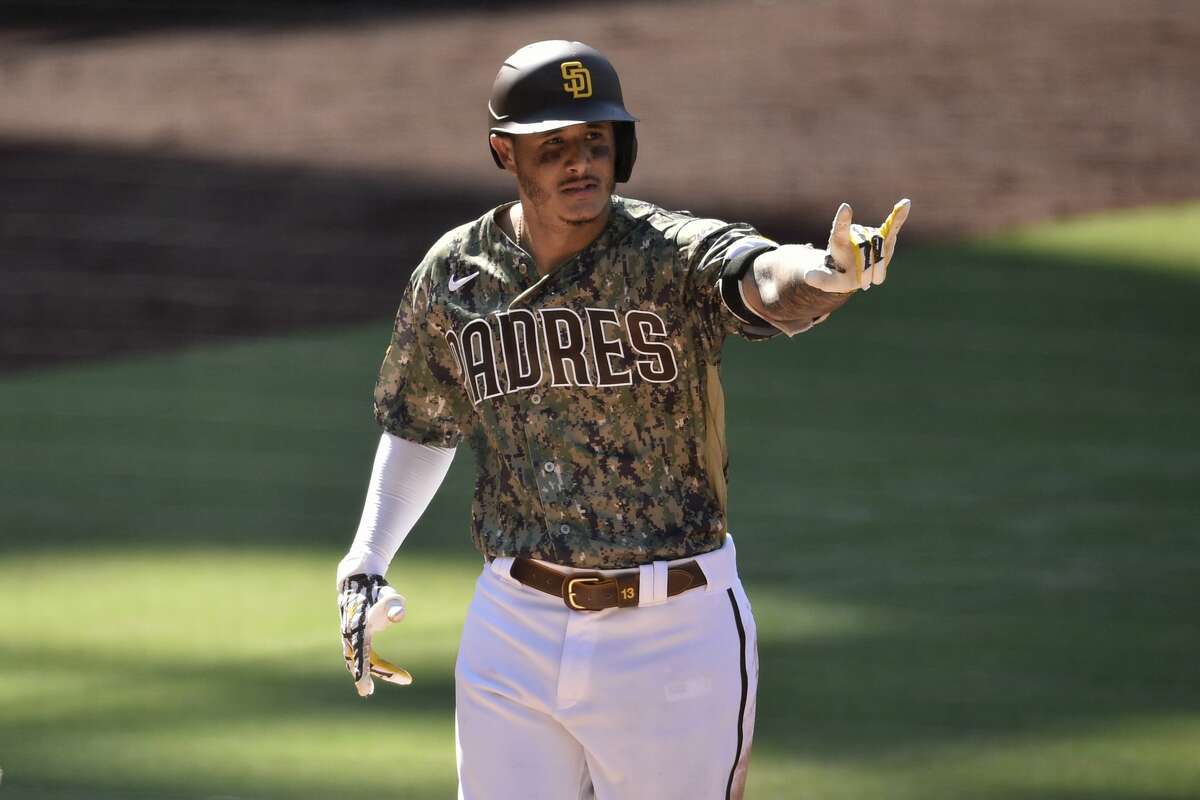 San Diego Padres' Manny Machado celebrates while crossing home on a two-run home run during the eighth inning of a baseball game against the Houston Astros in San Diego, Sunday, Aug. 23, 2020. (AP Photo/Kelvin Kuo)