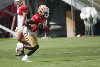 Santa Clara, California, USA. 18th Oct, 2020. San Francisco 49ers wide  receiver Brandon Aiyuk (11) celebrates touchdown with team member in front  of TV screen on Sunday, October 18, 2020, at Levis