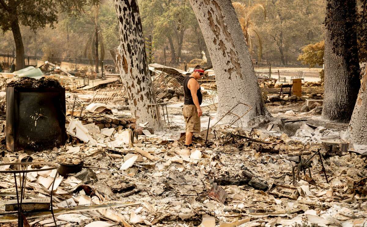 Resident Cliff Giannuzzi looks over the charred remains of his home during the LNU Lightning Complex fire in Vacaville, California on August 23, 2020. - Firefighters battled some of California's largest-ever fires that have forced tens of thousands from their homes and burned one million acres, with further lightning strikes and gusty winds forecast in the days ahead.
