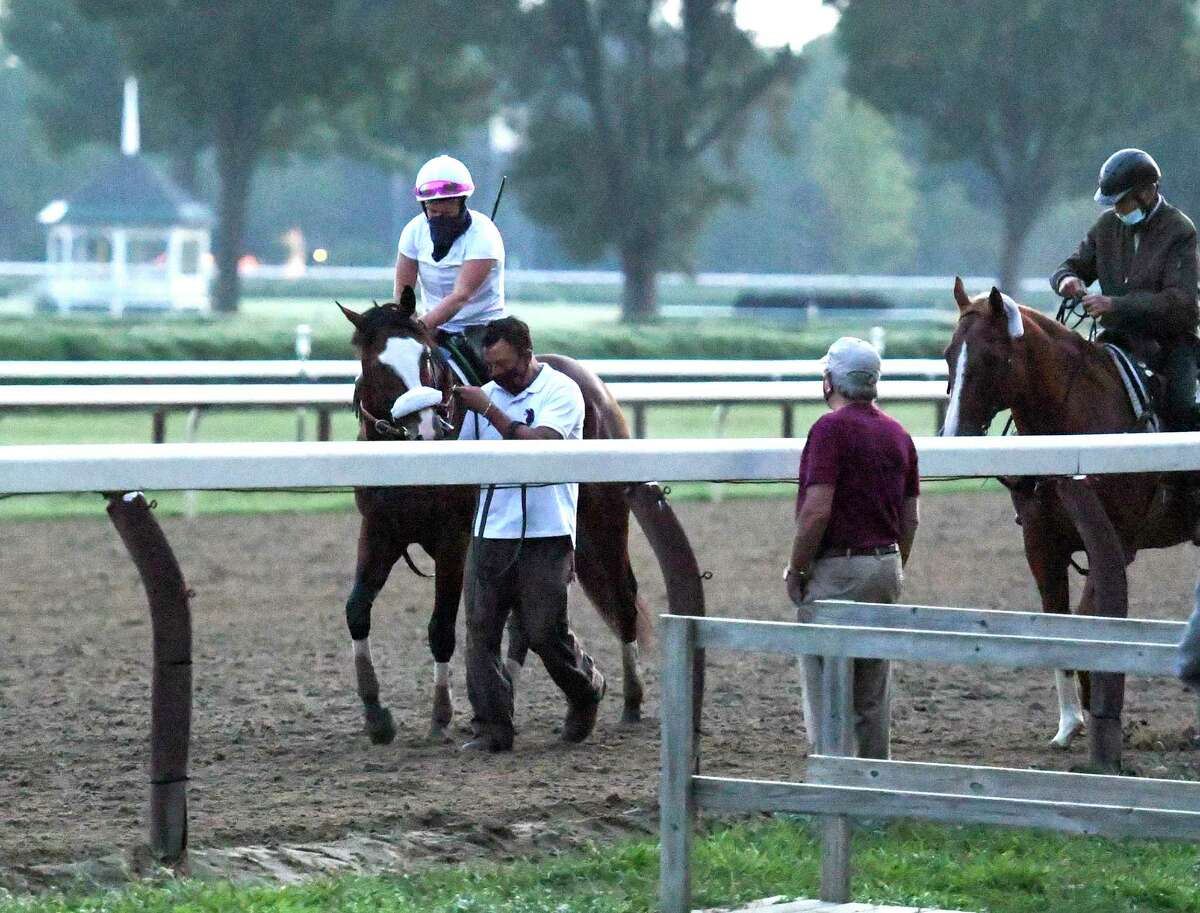 As Jack Knowlton, managing partner of Sackatoga Stables watches from the side of the track Tiz the Law with exercise rider Heather Smullen aboard returns to the barn after one of his final preparatory works before the Kentucky Derby Sunday Aug.23, 2020 at the Saratoga Race Course in Saratoga Springs, N.Y. Photo by Skip Dickstein/Special to the Times Union