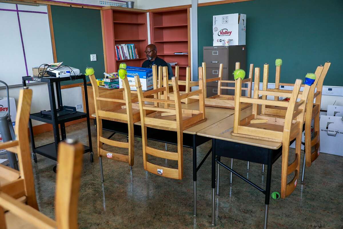 Fourth-grade teacher Mr. Peter Wilson teaches a zoom class from his empty classroom at Sankofa Academy on the first day of school on Monday, Aug. 10, 2020 in Oakland, California.
