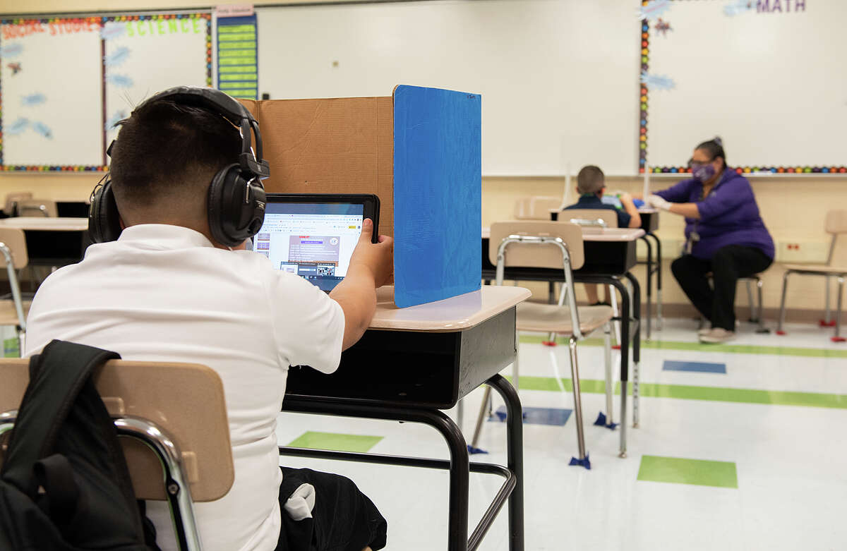 M.S. Ryan Elementary student Elias Lozano listens to the material provided by his teacher in their virtual classroom, Aug. 24, 2020, during the first day back to school for some students during the COVID-19 Coronavirus pandemix.
