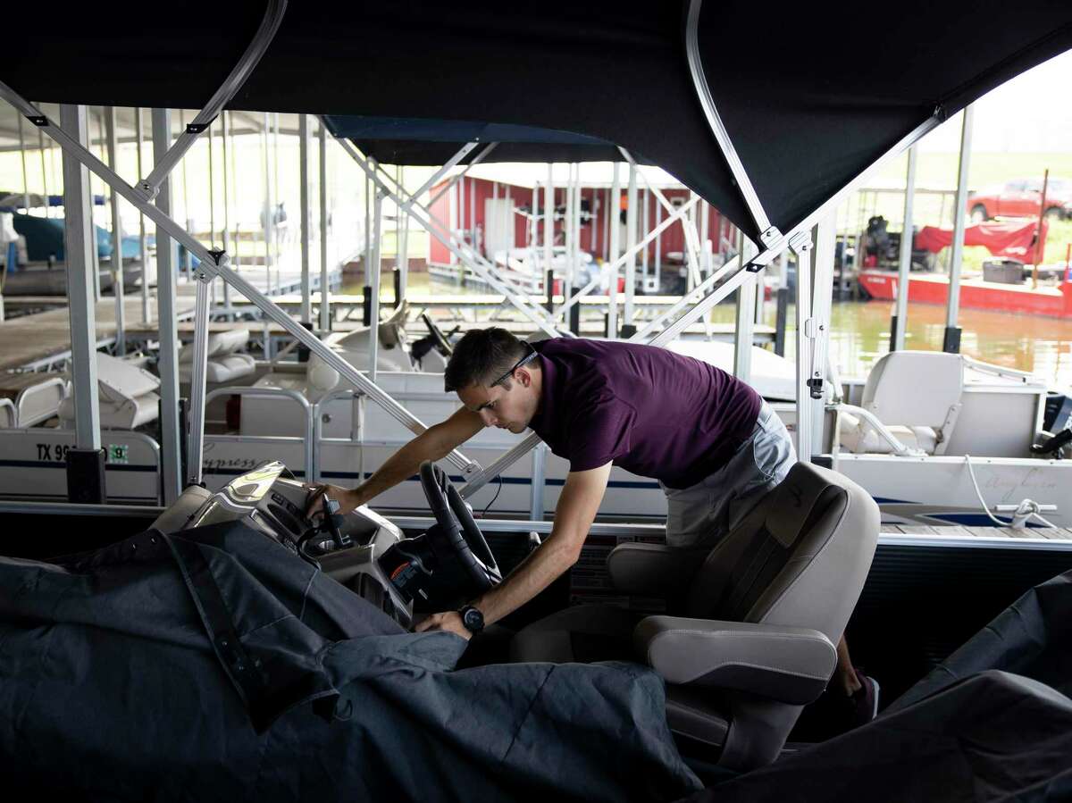 Alex Cade, manager at the Palms Mariana prepares a boat for the possibility of inclement weather as Tropical Storm Laura approaches the area, Monday, Aug. 24, 2020, in Conroe. Tropical Storm Laura is expected to make landfall Wednesday night according to the National Weather Service.