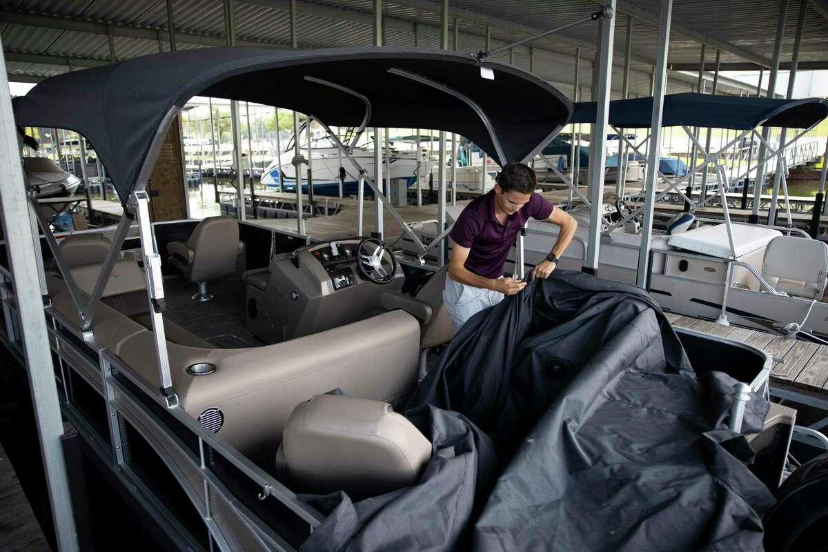 Alex Cade, manager at the Palms Mariana prepares a boat for the possibility of inclement weather as Tropical Storm Laura approaches the area, Monday, Aug. 24, 2020, in Conroe. Tropical Storm Laura is expected to make landfall Wednesday night according to the National Weather Service.