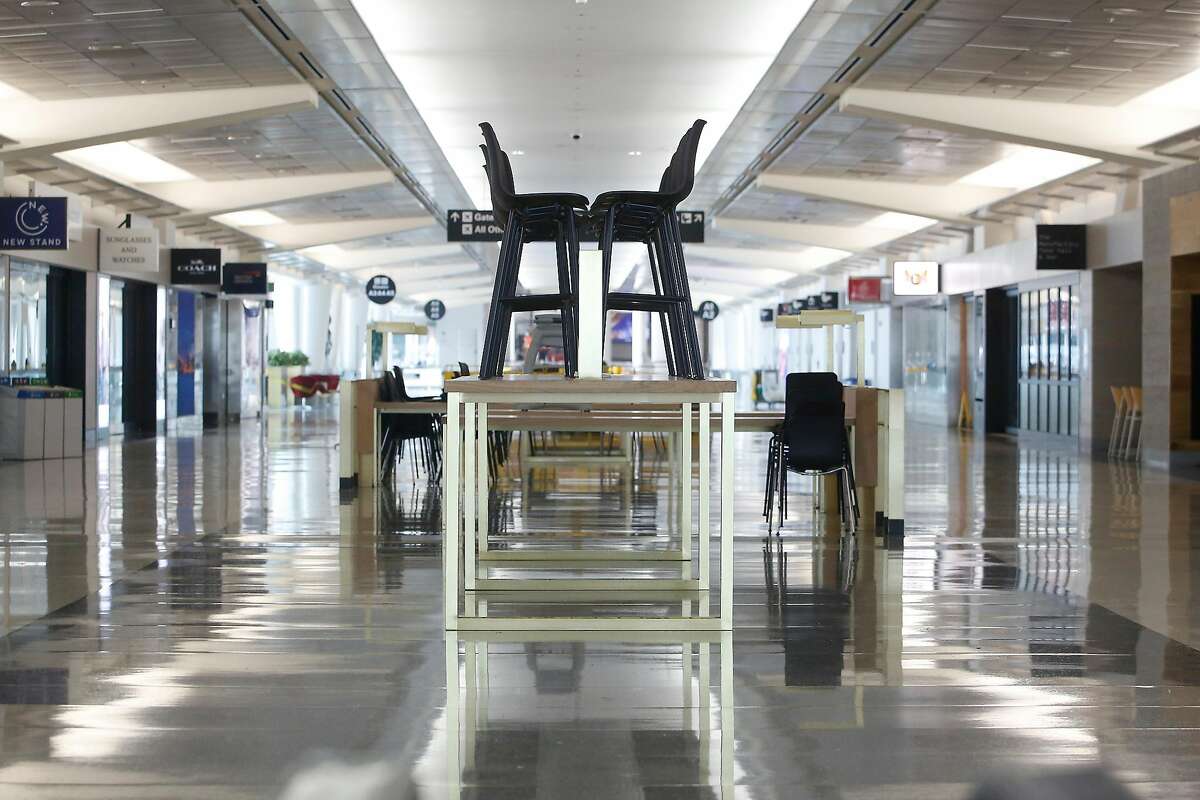 Chairs are seen atop a table in Concourse A of the SFO International Terminal on Monday, August 24 2020 in San Francisco, Calif. Concourse A in the International Terminal at SFO has been shut since April due to the pandemic.