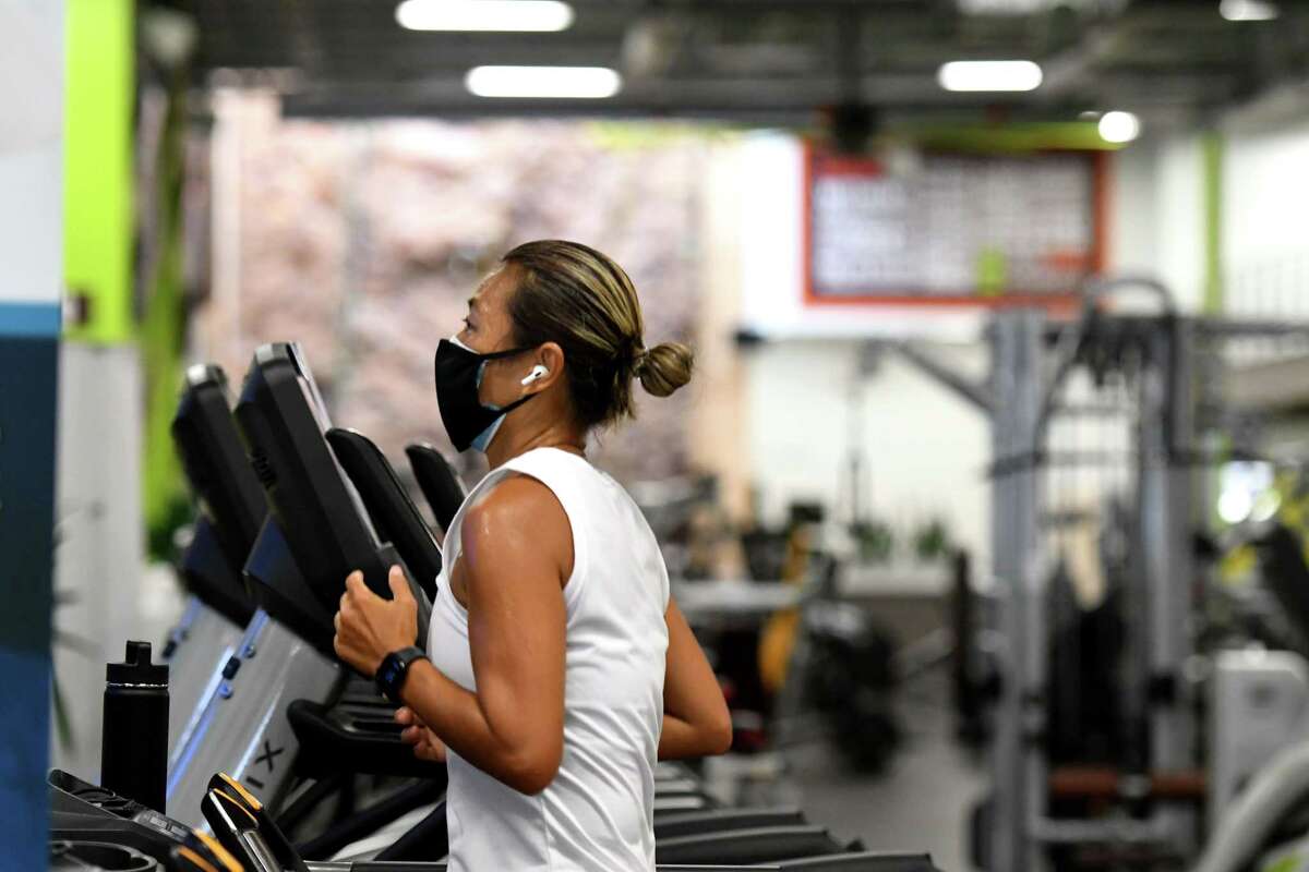 Grace Ng hits the treadmill at Vent Fitness during the first day of gym reopening under the state's coronavirus reopening plan on Monday, Aug. 24, 2020, in Guilderland, N.Y. (Will Waldron/Times Union)