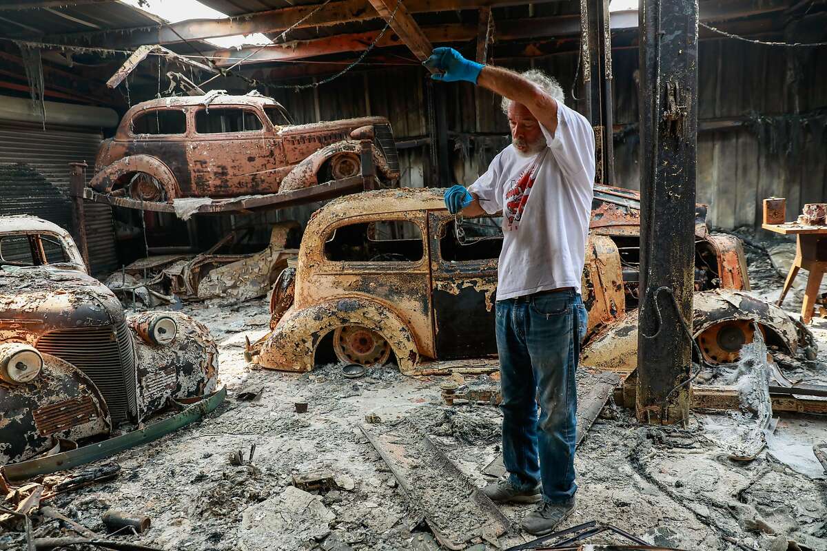 Ken Albers, 72, wipes his head as he takes a break from sifting through the charred remains of his destroyed vintage cars after the LNU Lightning Complex fire tore through the area on Monday, Aug. 24, 2020 in Vacaville, California.