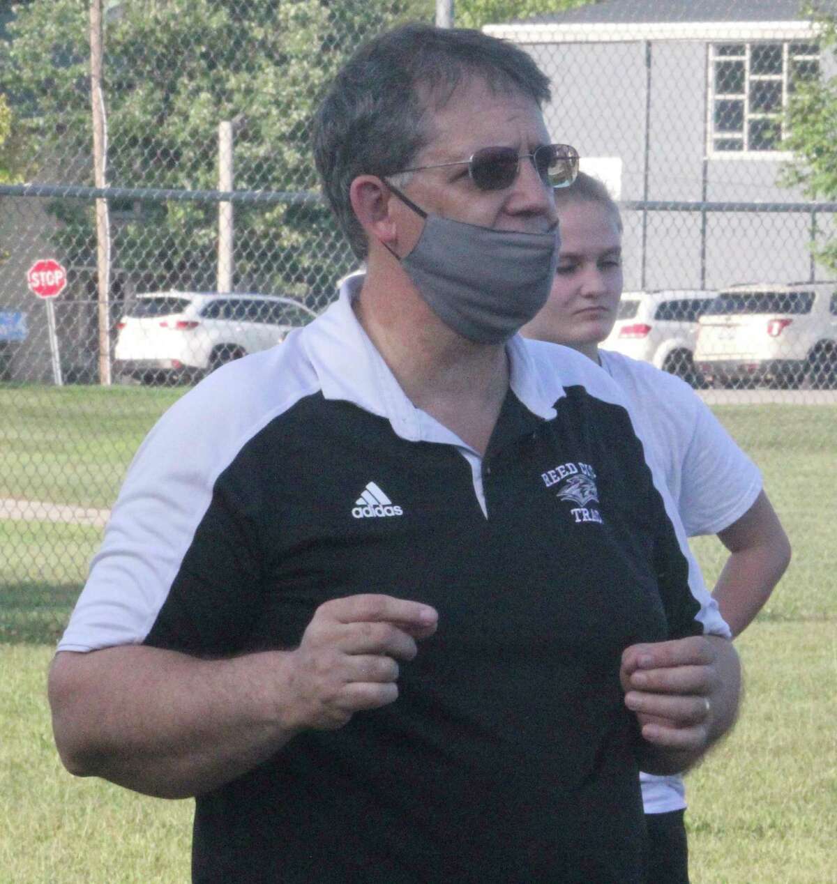 Reed City volleyball coach Don Patterson talks to his team at a recent outdoor practice. (Pioneer photo/John Raffel)
