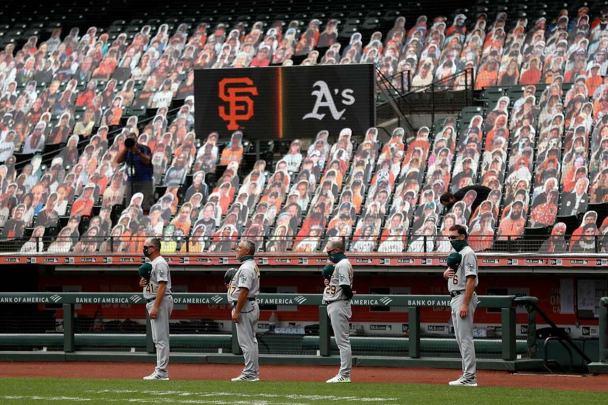 Oakland Athletics' coaches Al Pedrique, Mike Aldrete and Ryan Christenson and manager Bob Melvin stand for National Anthem before playing San Francisco Giants during MLB game at Oracle Park in San Francisco, Calif., on Sunday, August 16, 2020.