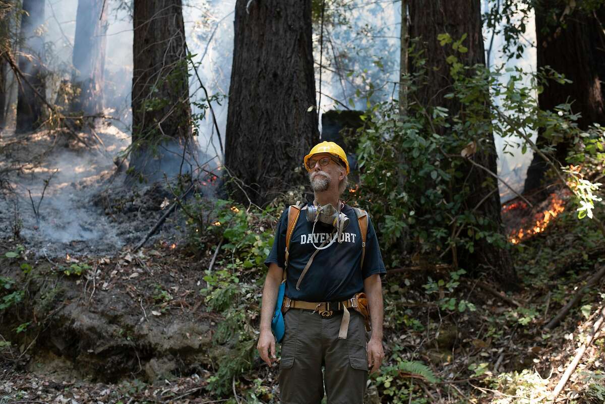 Ethan Summers stands in front of a fire break on the hillside above Smith Grade, describing his efforts to defend the Boony Doon area from the CZU Lightning Complex Fire on Aug. 24, 2020. Summers is part of a neighborhood that has banded together and stayed behind in an evacuation zone to defend their homes against the fire.