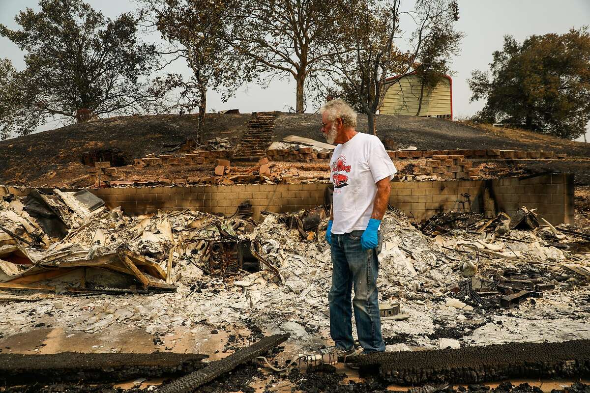 Ken Albers, 72, goes through the charred remains of his property off of English Hills Road after the LNU Lightning Complex fire tore through the area on Monday, Aug. 24, 2020 in Vacaville, California.