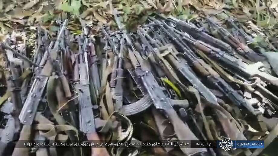 This image distributed online by the Islamic State Central Africa Province (ISCAP) and provided by SITE Intelligence Group shows weapons piled up following clashes with Mozambican government troops on Thursday, Aug. 6, 2020, near Mocimboa da Praia, in northern Mozambique. The stinging success of Mozambique's Islamic extremist rebels in seizing and holding the northern port city signals to the government, neighboring countries and the world that Africa has yet another insurgency hotspot. Writing in Arabic reads "Blessings of God are on the soldiers of the caliphate after their attack on the Mozambican army near the city of Mocimboa da Praia". (SITE Intelligence Group via AP) Photo: Associated Press