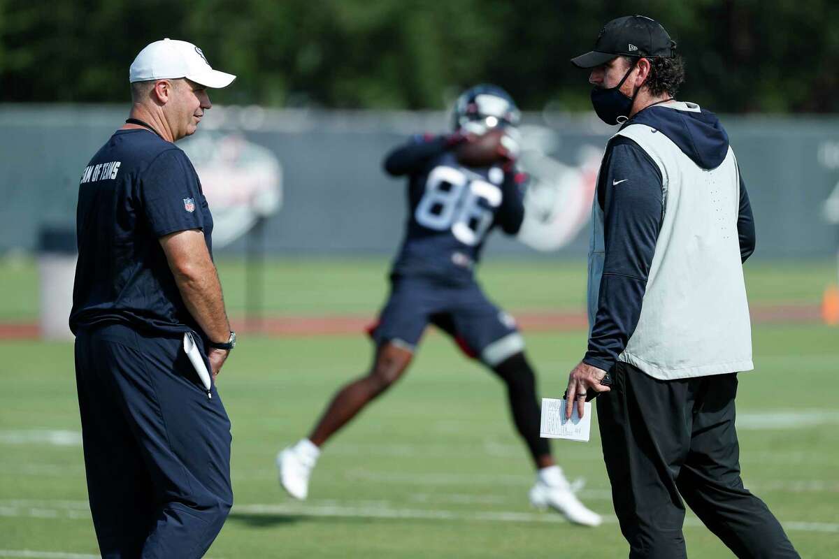 Houston Texans head coach Bill O'Brien, left, talks to offensive coordinator Tim Kelly during an NFL training camp football practice Tuesday, Aug. 25, 2020, in Houston.