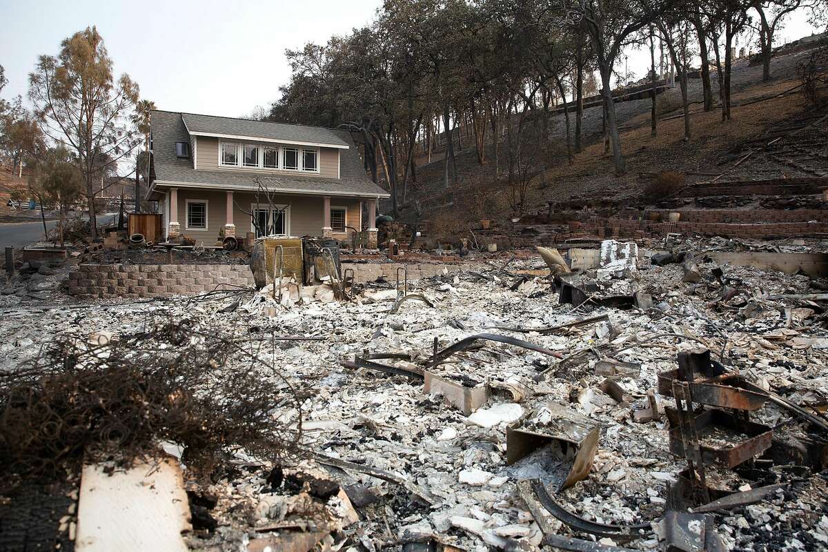 A single unburned house stands next to the remains of the house next to it in the Berryessa Highlands neighborhood near Lake Berryessa, Calif. on Monday, August 24, 2020. The area was recently devastated by the LNU Complex fire that was started by lightning on August 16.
