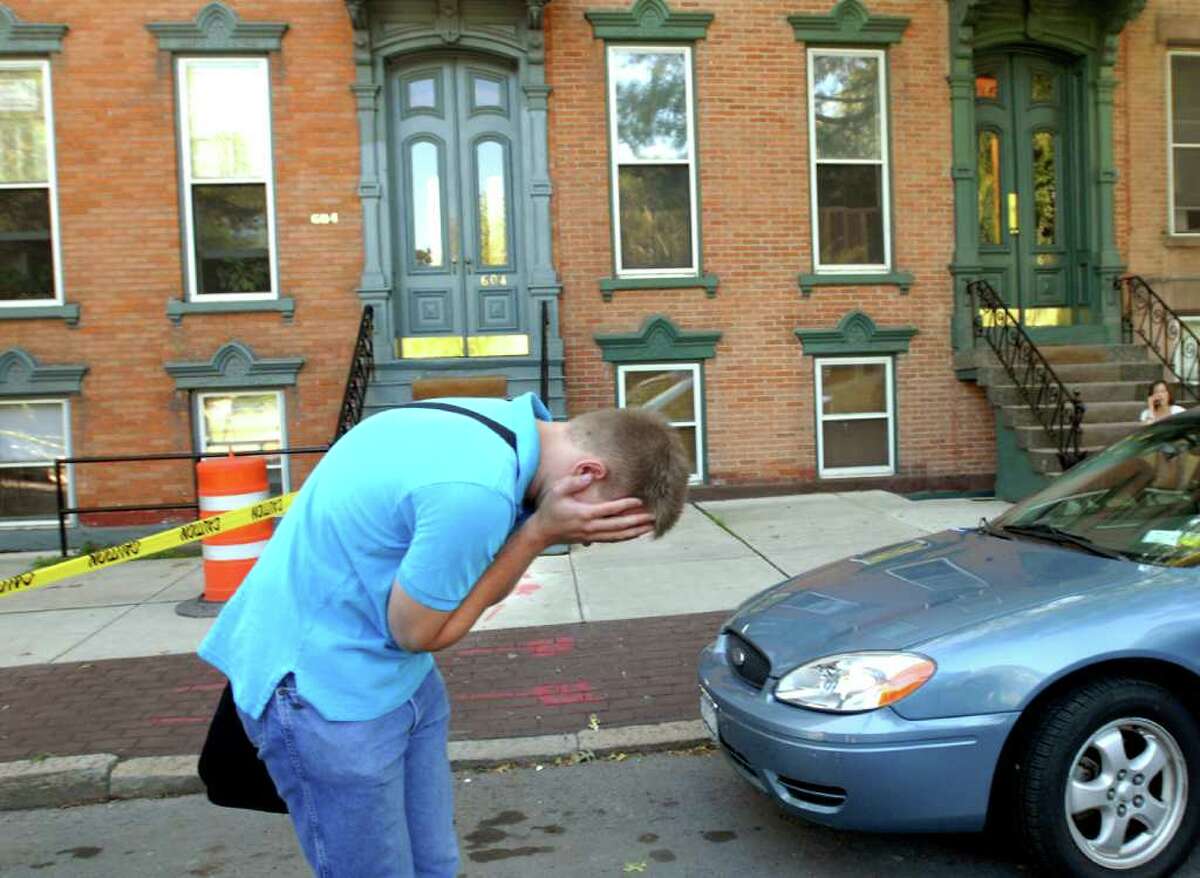 Phillip Suruda, 21, who lives in the basement apartment at 600 Madison Ave., arrives home to find the building has partially collapsed on Friday, Aug. 27, 2010, in Albany, N.Y. (Cindy Schultz / Times Union)