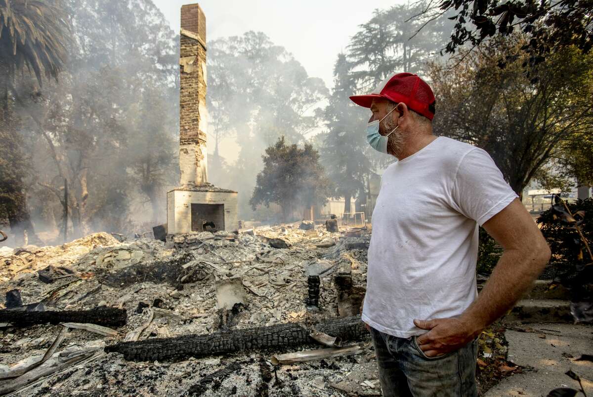 Jered Lawson, co-founder of the non-profit farm education center Pie Ranch, surveys the ruins of their historic 157-year old farmhouse that was destroyed Thursday morning, Aug., 21, 2020, in Pescadero by the CZU Complex fire.