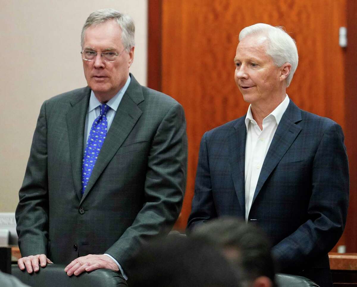 Defense attorney Tim Johnson, left, and Richard Rowe, Arkema CEO, right, are shown during the Arkema Inc. criminal trial at Harris County Criminal Courthouse, Monday, March 2, 2020, in Houston. Arkema Inc., a subsidiary of a French chemical manufacturer, along with three senior staff members are on trial over a fire at the Houston-area chemical plant that was overwhelmed by Hurricane Harvey's flooding in 2017. (Melissa Phillip/Houston Chronicle via AP)