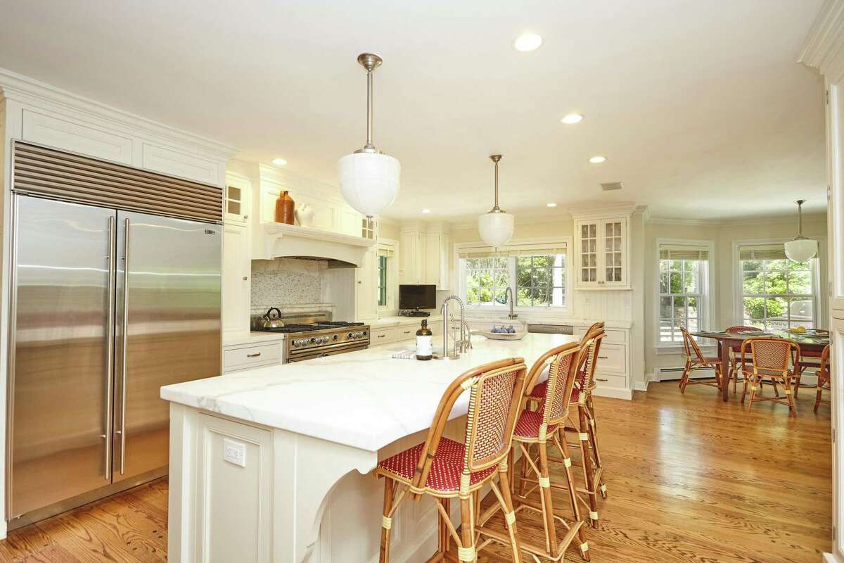 In the gourmet eat-in kitchen there are marble counters, a center island, built-in desk or home command area, and a breakfast or casual dining area. That's there to enjoy year-round if one is ever tempted to stray from this secluded property, which offers indoor-outdoor living, entertaining, relaxing, and engaging in sports and recreational activities. Multi-level stone patios and pathways lead to the property's amenities. The original colonial house was built in 1935 and over the years it was renovated and expanded